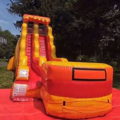 Fire-themed orange and red inflatable water slide
